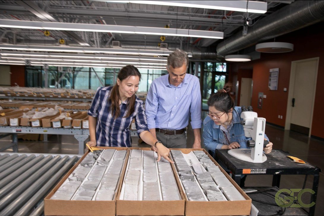 Geoscientists reviewing rock core samples in the lab
